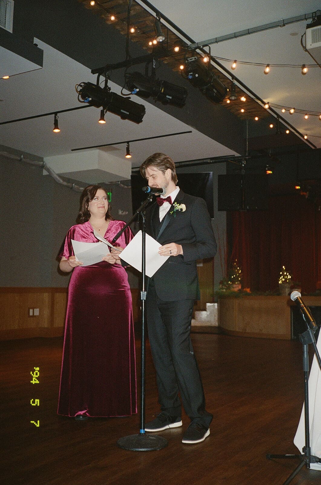 Candid wedding photos of two wedding party members giving a speech together at City Winery Boston.