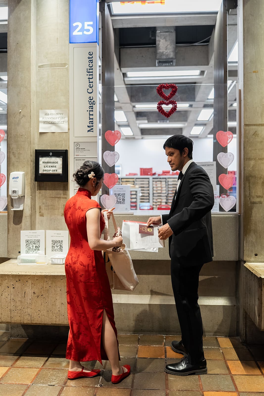 Couple completes paperwork at the marriage registration counter inside Boston City Hall.