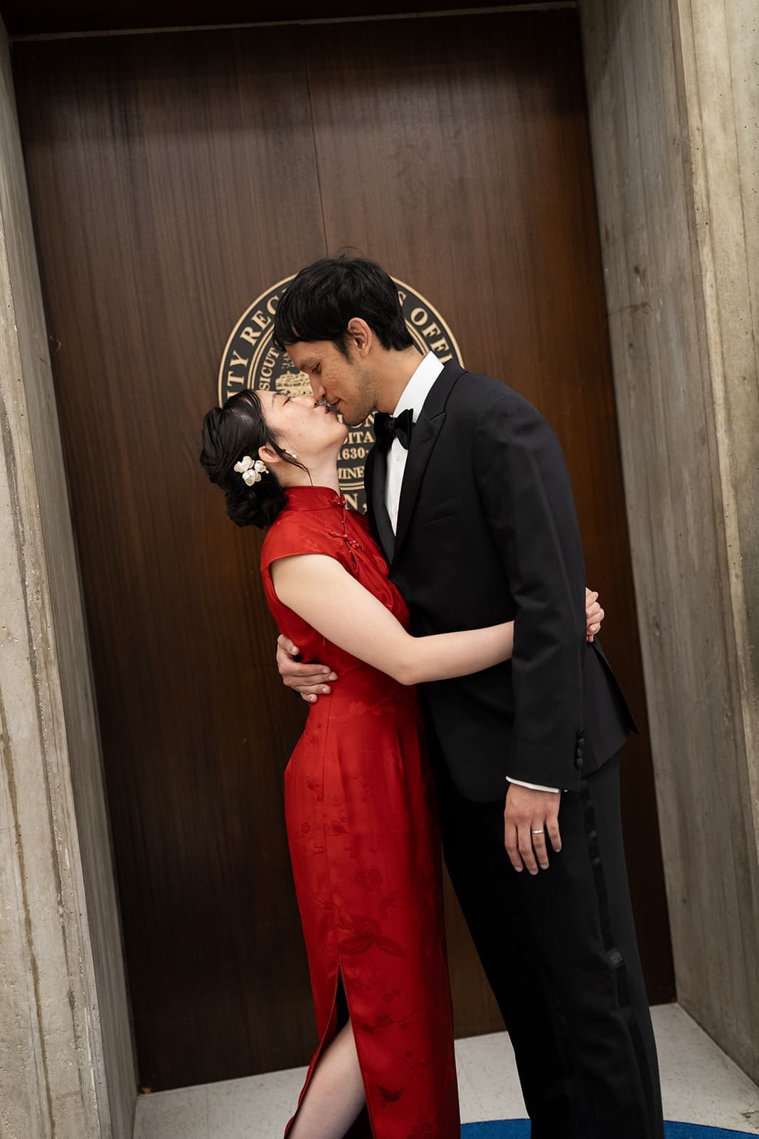 Newlyweds kiss outside the Registry Division following their Boston City Hall wedding.