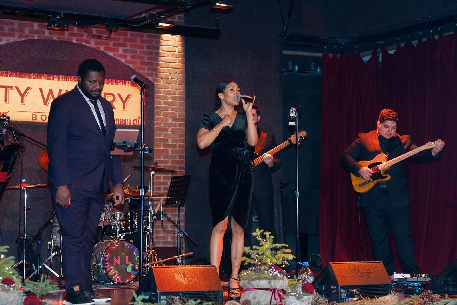 Candid wedding photos of a live band performing onstage at City Winery Boston.