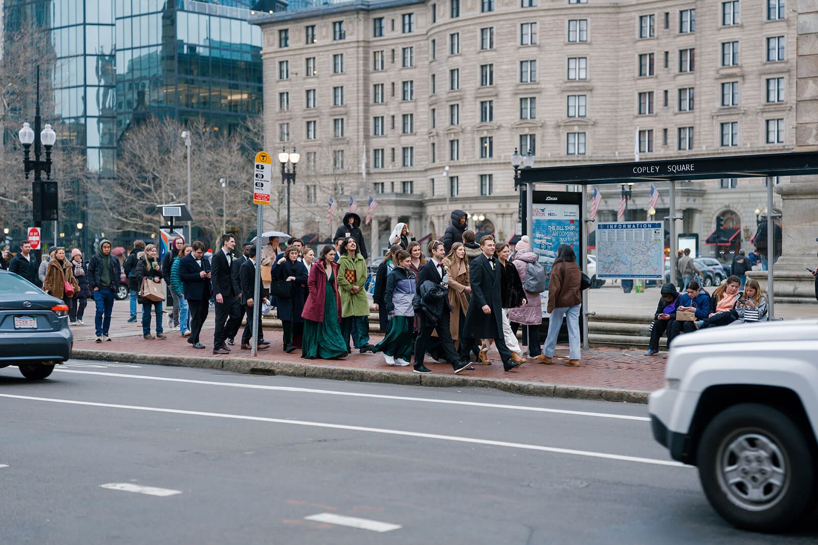 Wedding party and guests gathered near Copley Square while traveling through Boston after the ceremony.