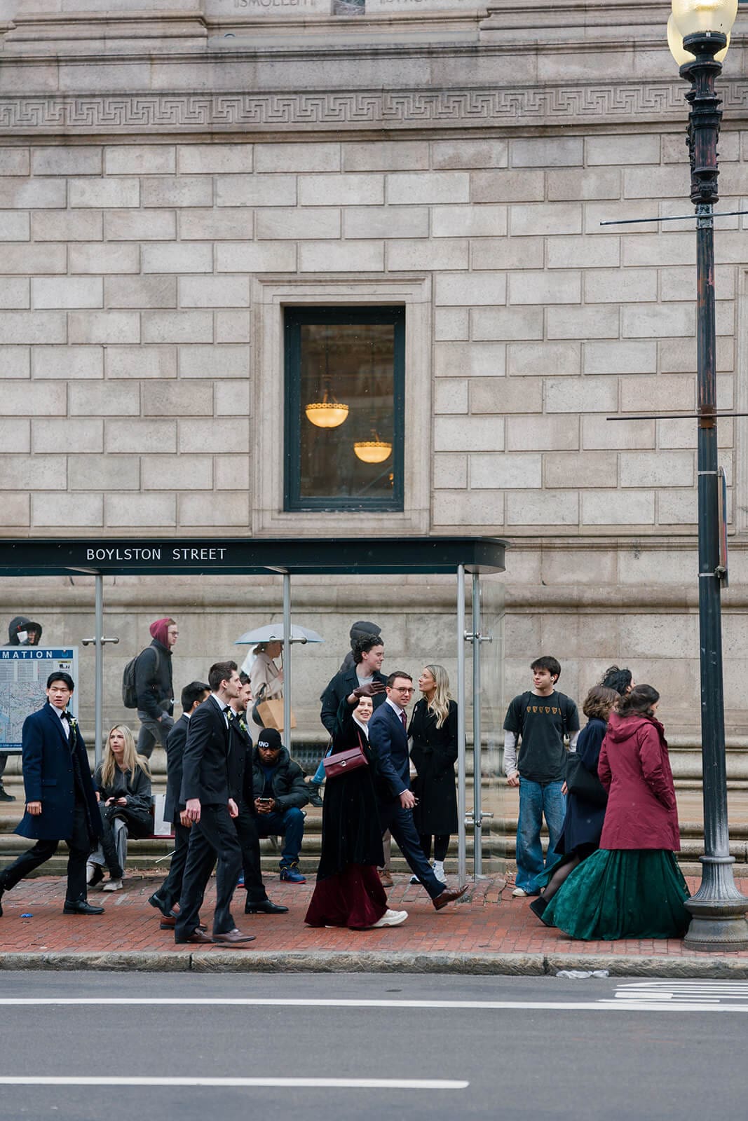 Wedding guests walking along a Boston street near Copley Square after a church wedding ceremony.