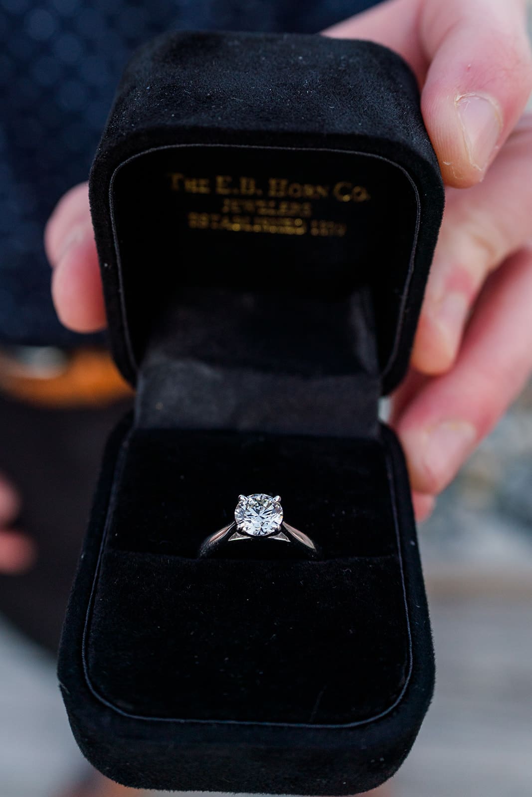 Diamond engagement ring displayed inside a black ring box